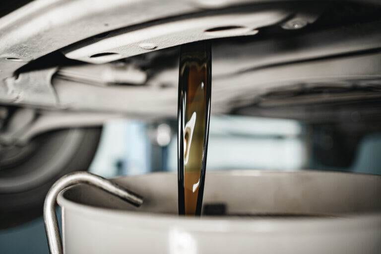 oil draining from a car during an oil change