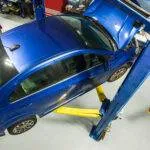 Blue Car on lift getting repairs