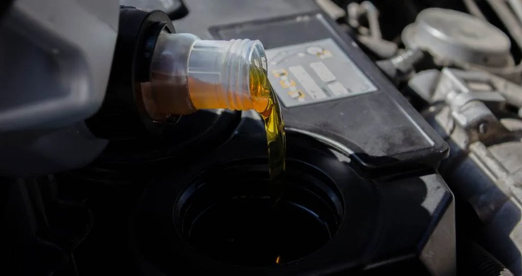 Adding oil to an automobile engine